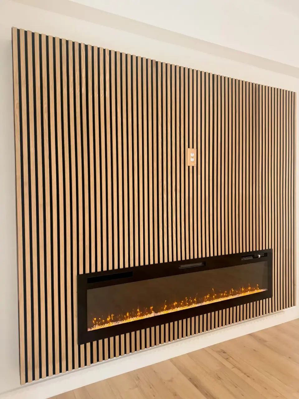 Fireplace wall clad in vertical wood slats