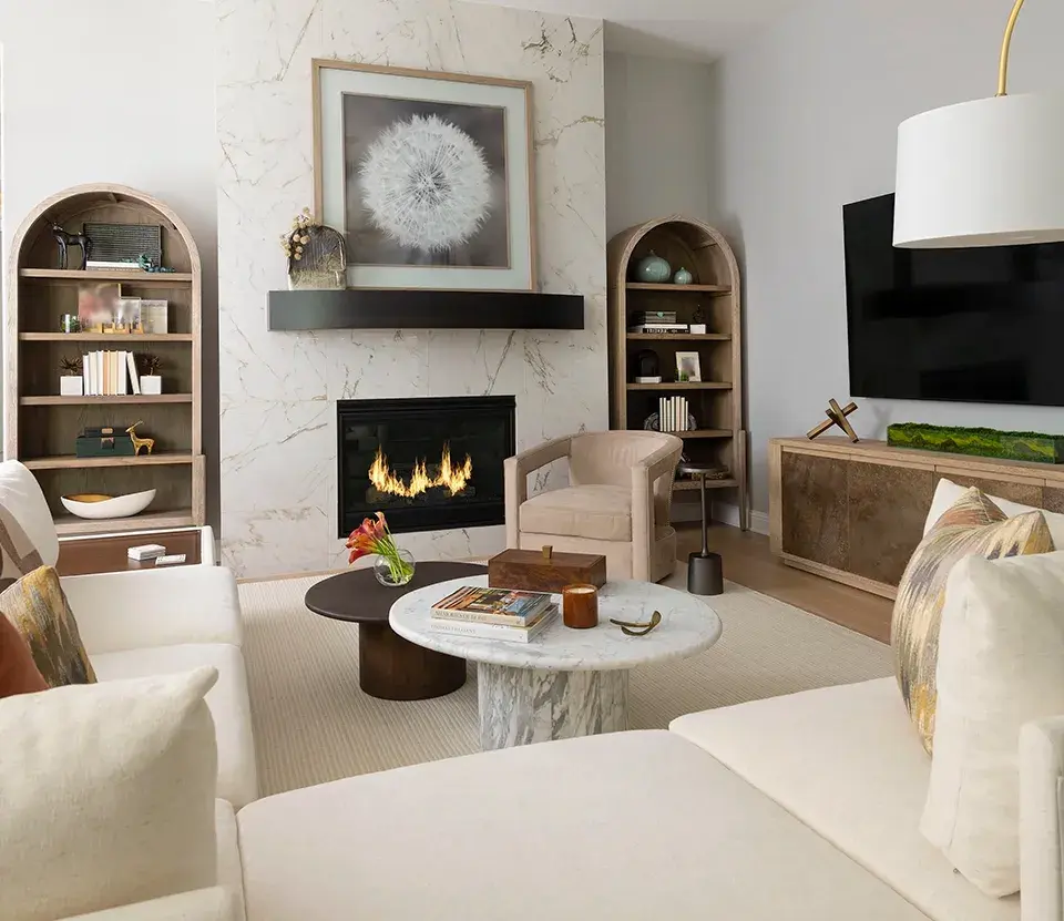 Living room with arched built-ins and a marble coffee table