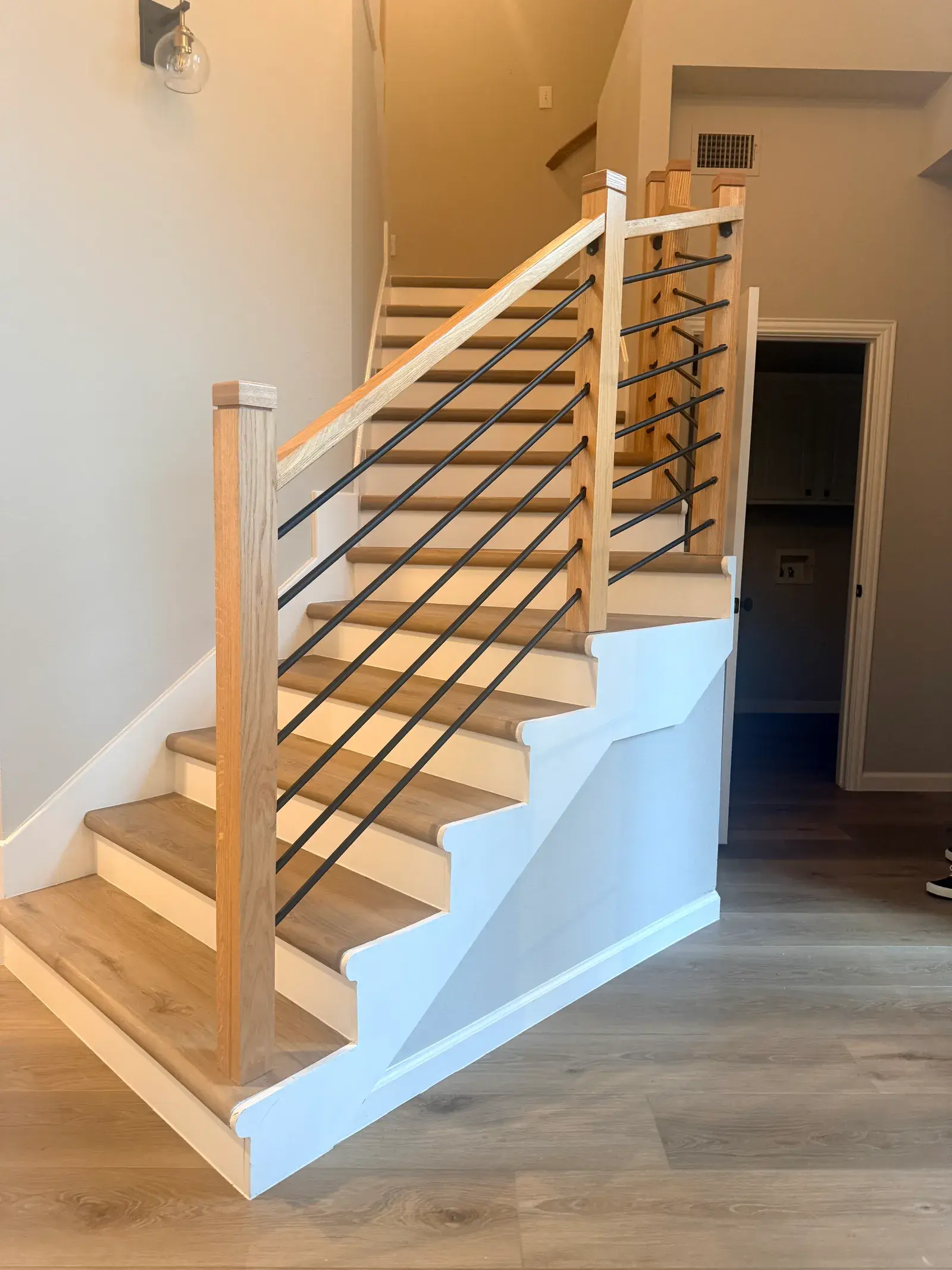 White oak stair treads with a black metal rail